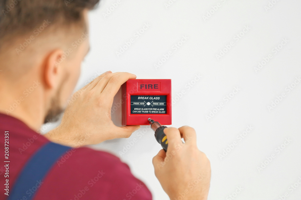 Electrician installing fire alarm system